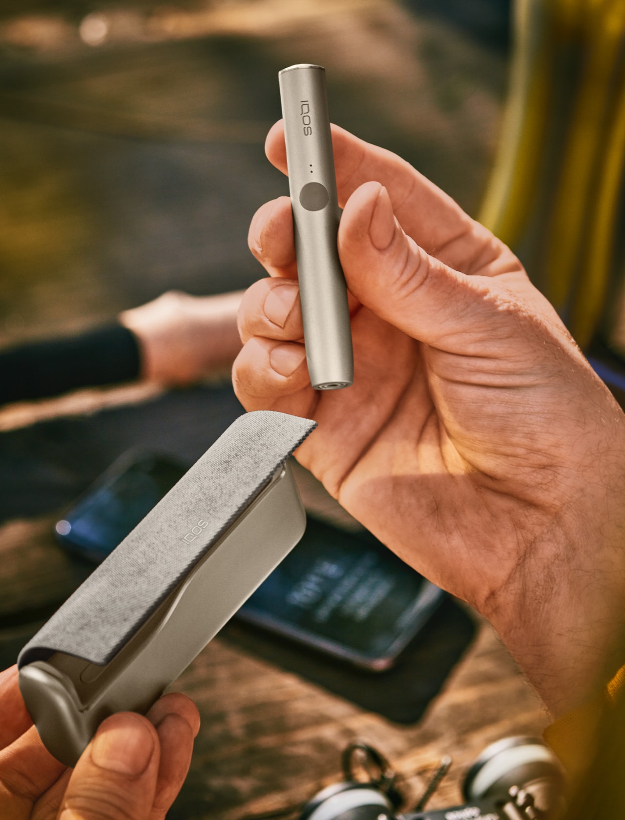 A man holding an IQOS device.