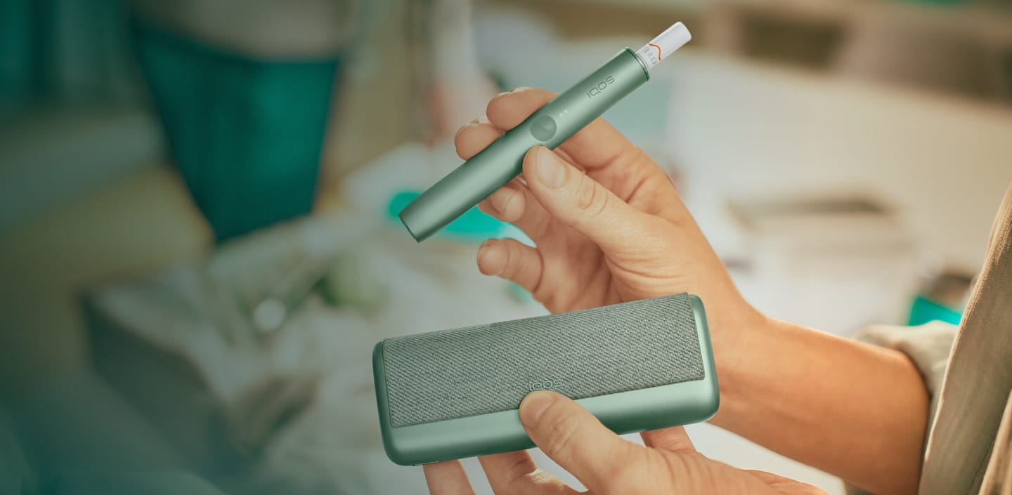 A jade green IQOS ILUMA PRIME Holder and Pocket Charger.