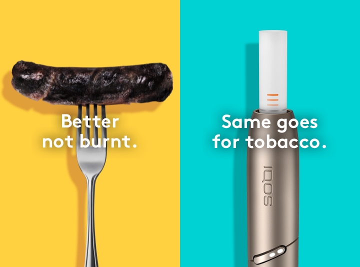 Burnt sausage on a fork compared to a clean IQOS HEETS stick in IQOS 3 DUO holder.